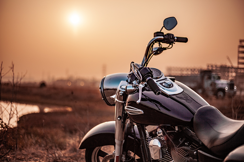 motorcycle in front of a sunset